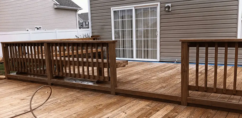 Deck sealing service protecting a backyard wood deck and railings in Fort Wayne, IN