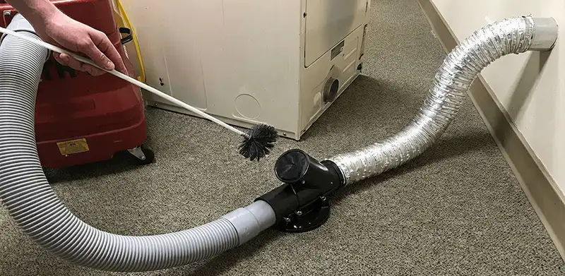 Dryer vent cleaning service removing lint from a dryer duct connection in Fort Wayne, IN
