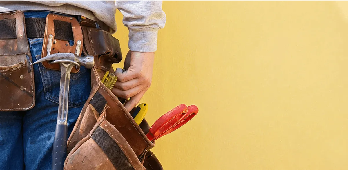 Handyman with tool belt ready for home repairs and maintenance in Fort Wayne, IN