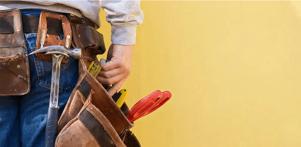 Handyman with tool belt ready for home repairs and maintenance in Fort Wayne, IN