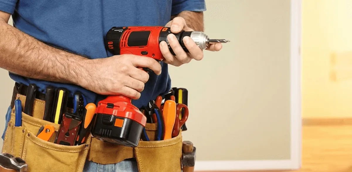 Handyman holding a power drill for home repairs and installations in Fort Wayne, IN