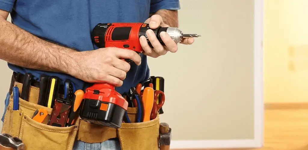 Handyman holding a power drill for home repairs and installations in Fort Wayne, IN